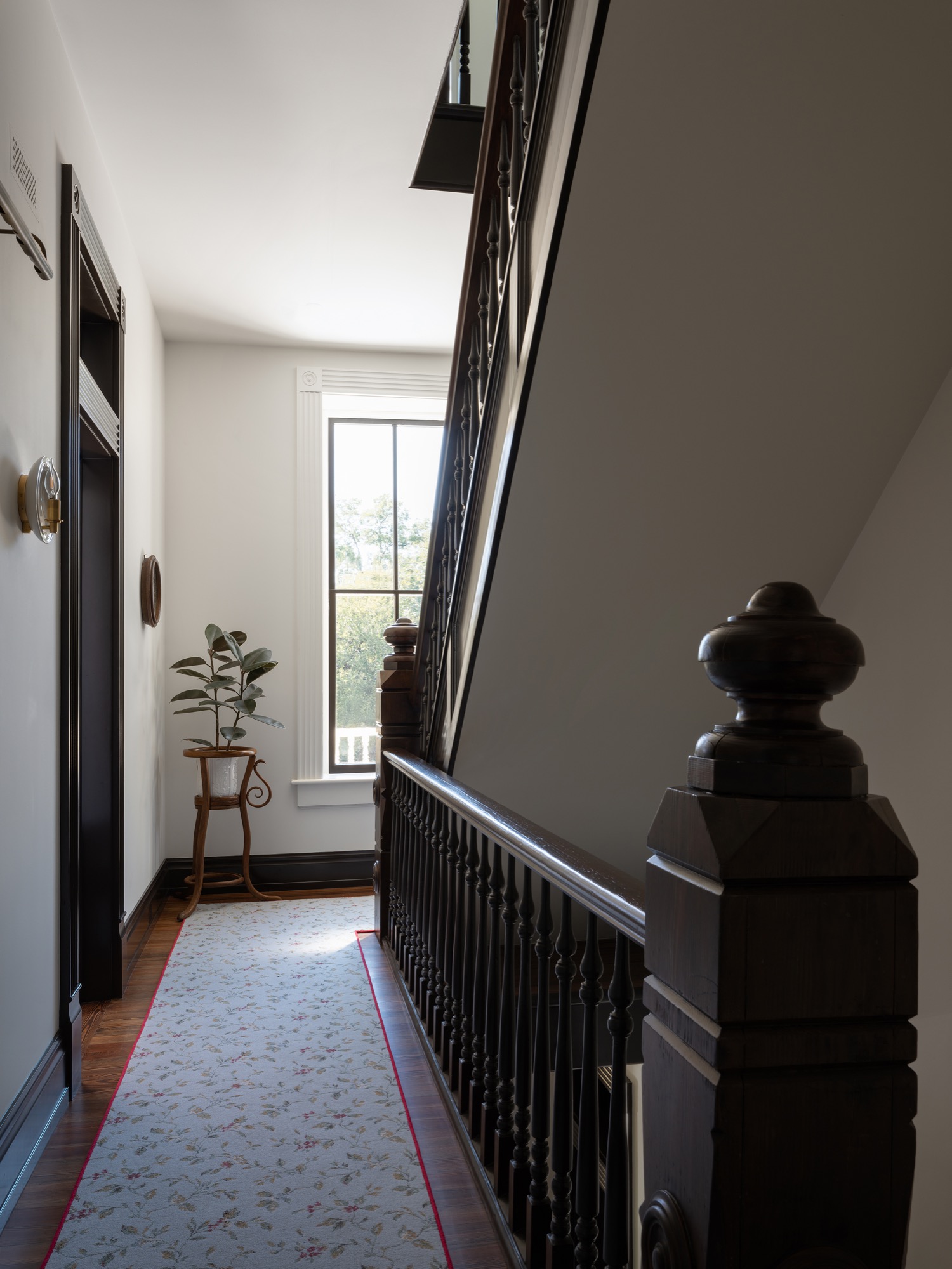 Victorian House stair hall with carved newel post in Austin, Texas